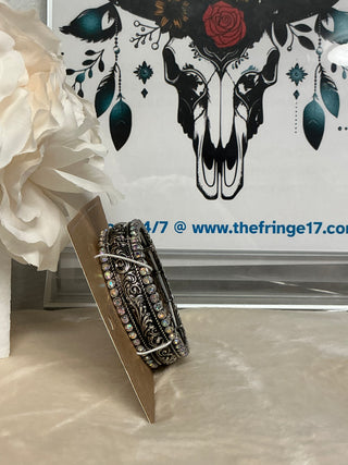 Wrist adorned with the Iridescent Stoneflare Silvertone Bracelet against a flowy boho blouse, capturing the essence of bold and brilliant western style.